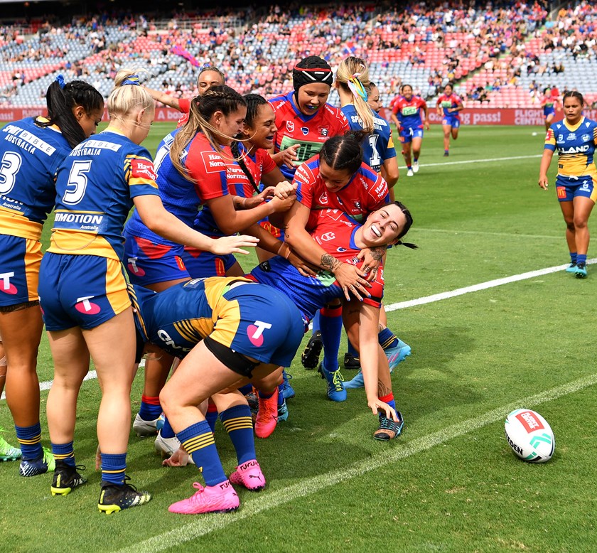 Romy Teitzel celebrates with her teammates after scoring the club's first try in the NRL women's premiership.