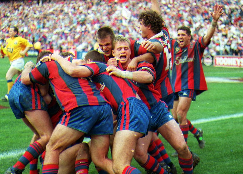 HISTORY: The 1997 team celebrate Darren Albert's historic try in an epic decider.