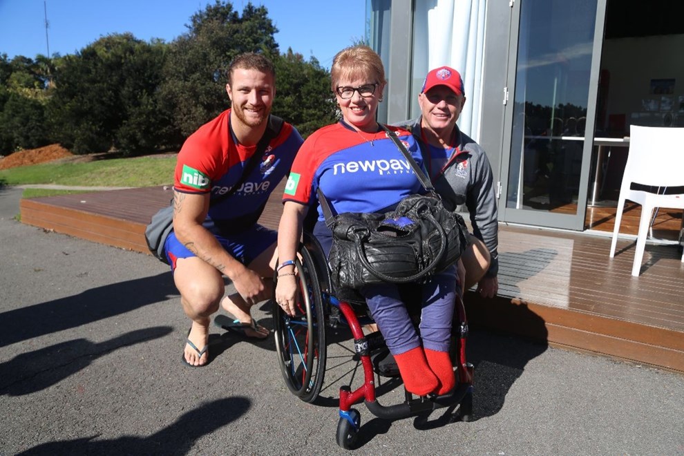Passionate Newcastle Knights Member Donna Gould shows off her new red and blue wheels to Korbin Sims and coach Rick Stone. 