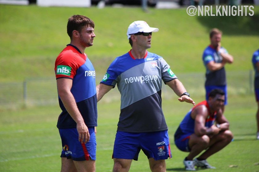 Young utility back Bryce Donovan receives some advice from assistant coach Mick Potter.